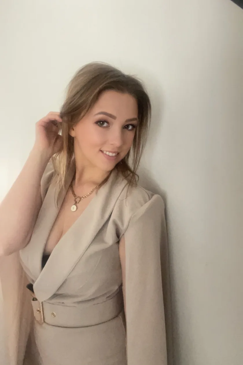 Demi in een beige blazer, in zacht natuurlijk licht